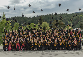 graduates tossing their caps after the graduation ceremony